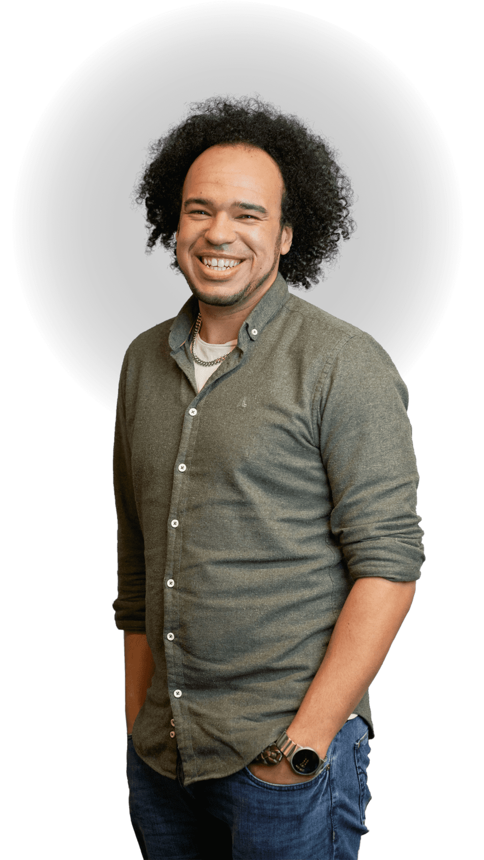 Standing portrait of Kyle Welsby smiling with iconic curly hair